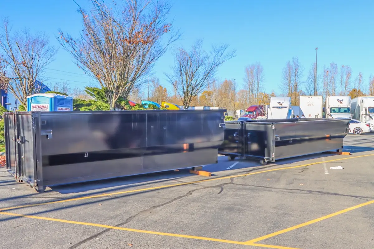 Professional dumpster rental service with roll-off container on residential driveway in La Quinta